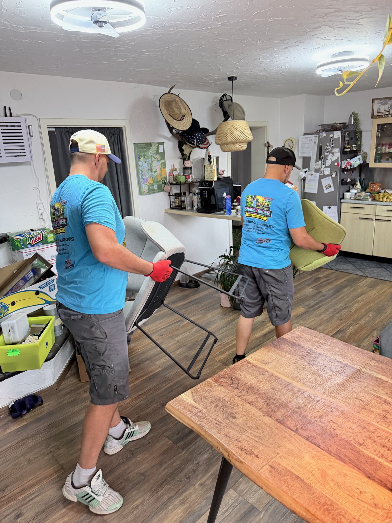 Chaos2Order team members carrying chairs inside a property