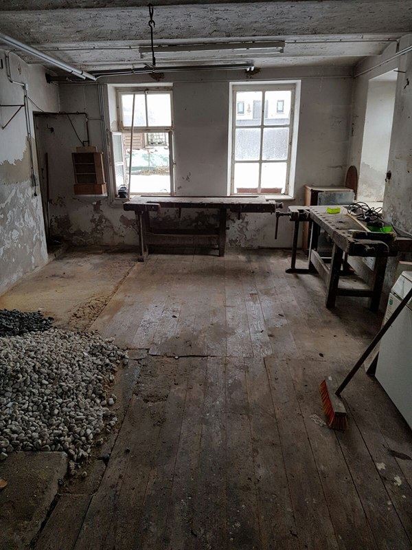 Interior work area with exposed surfaces and loose rubble
