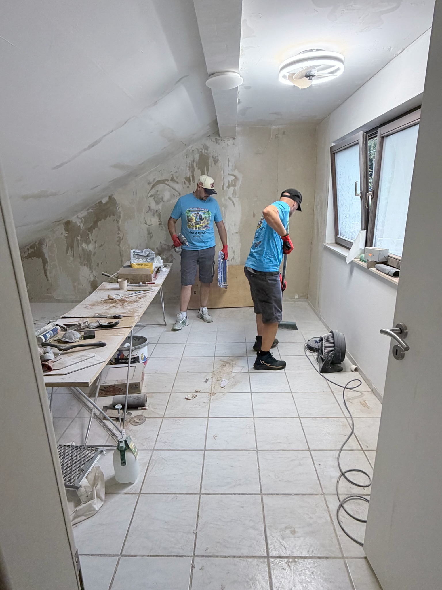 Chaos2Order crew working in a room with loose material and debris