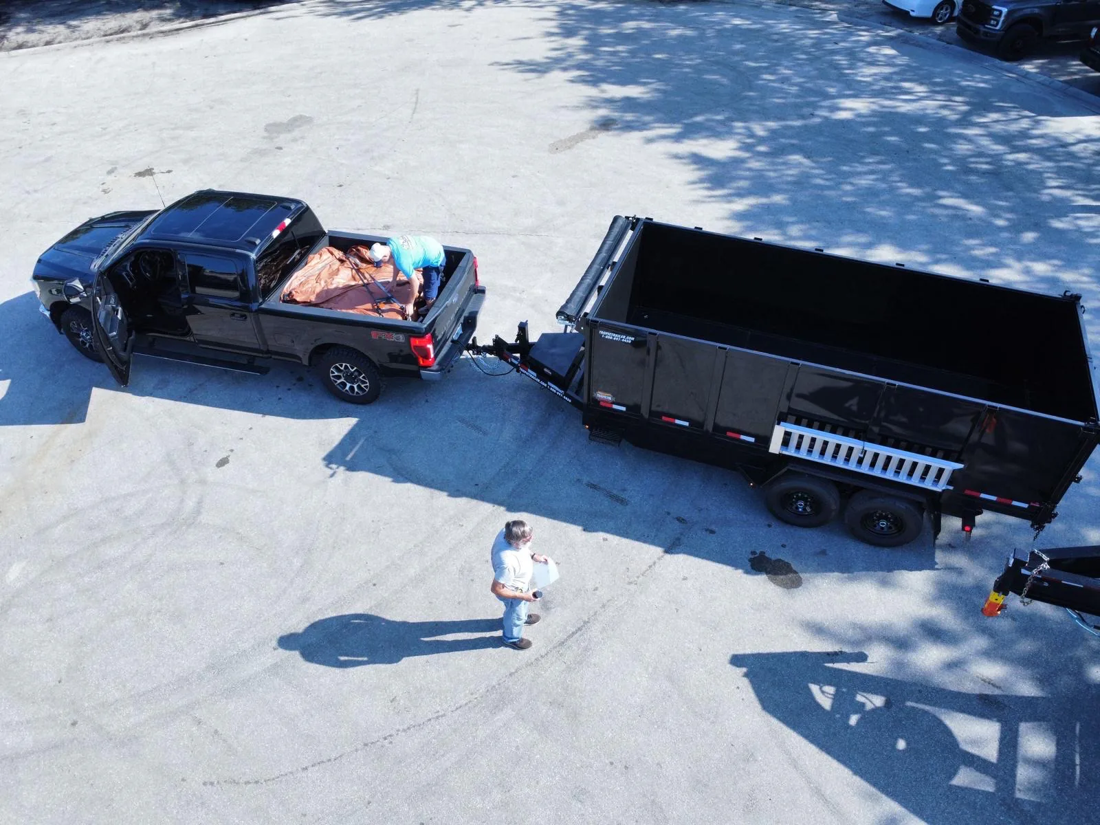 Pickup truck and open trailer used for hauling and debris removal