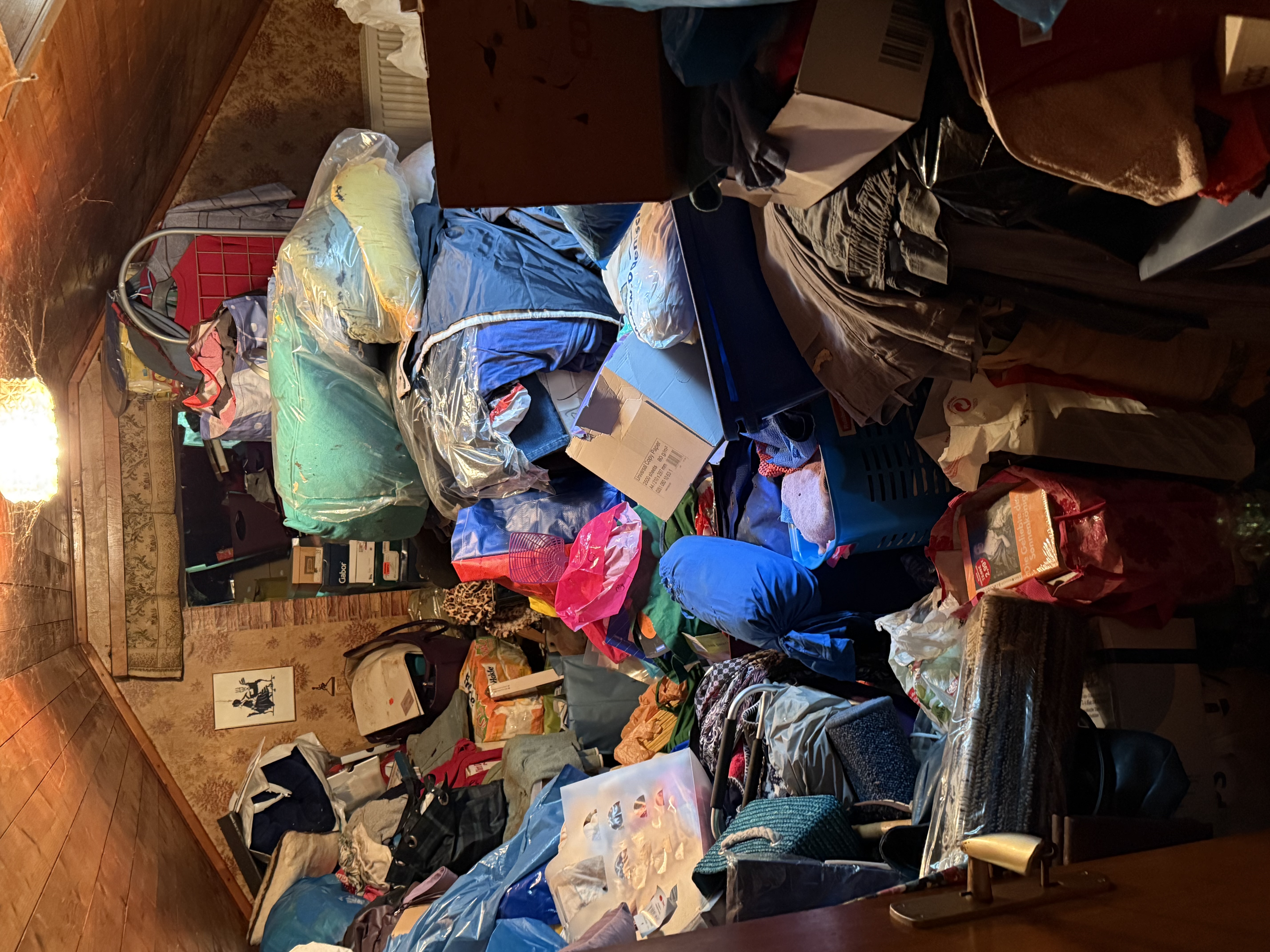 Attic space filled with boxes, bags, and household contents
