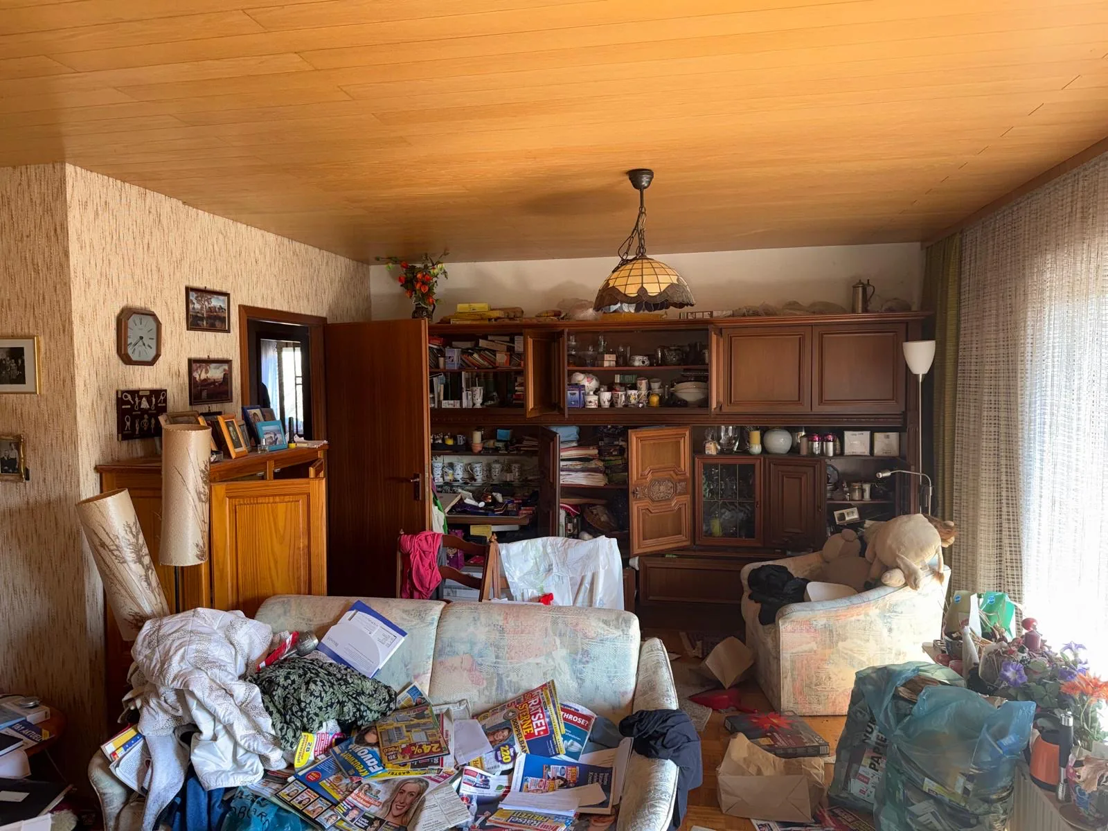 Cluttered residential room prepared for junk removal