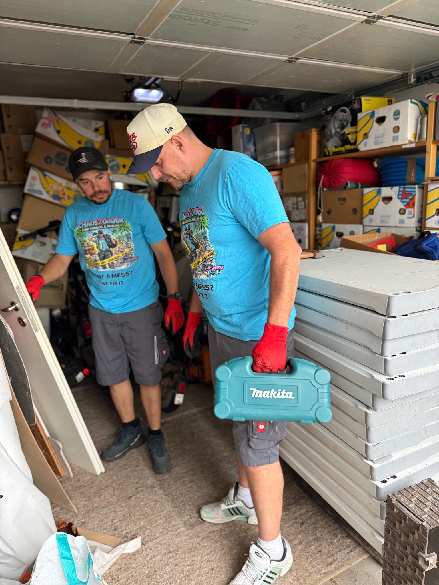 Chaos2Order crew members clearing tools and equipment from a garage