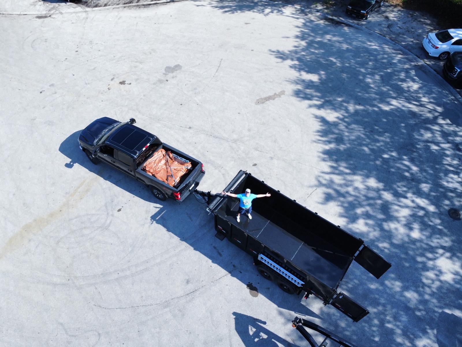 Aerial view of a pickup truck and open hauling trailer