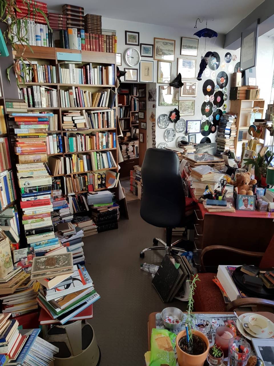 Room filled with books, records, and household contents before a cleanout